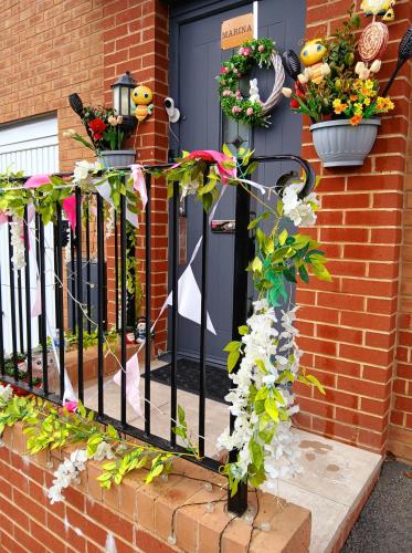 a wrought iron fence with flowers on a house at Marina & Seagulls in East Cowes