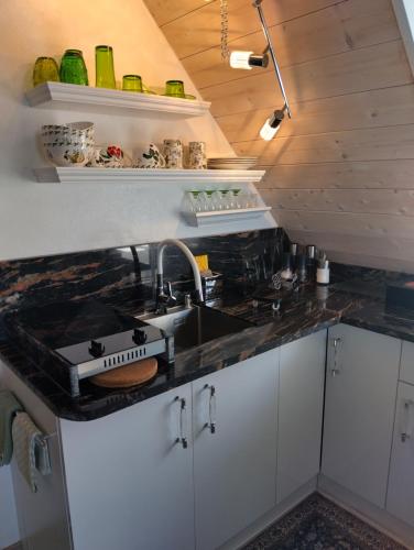 a kitchen with a sink and a stove at Haus "Guck - ins - Tal" in Sasbachwalden