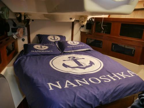 a bed on a boat with the name of namossein at Nanoshka Yacht in Tel Aviv