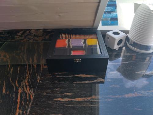a black drawer with books in it on the floor at Haus "Guck - ins - Tal" in Sasbachwalden