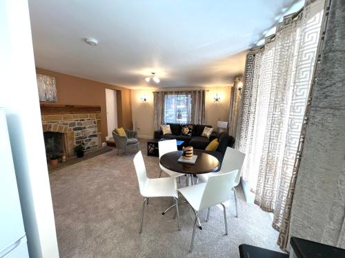 a living room with a table and chairs at Ground Floor 2 Bedroom Apt, Onsite Parking, Edge of Glastonbury and Street in Street