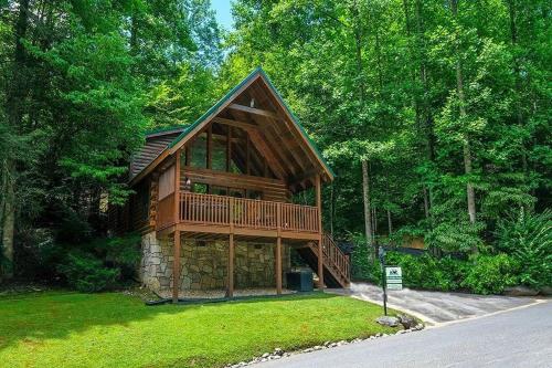 a large wooden cabin in the middle of a forest at Yeti Lodge by Avada Properties in Gatlinburg