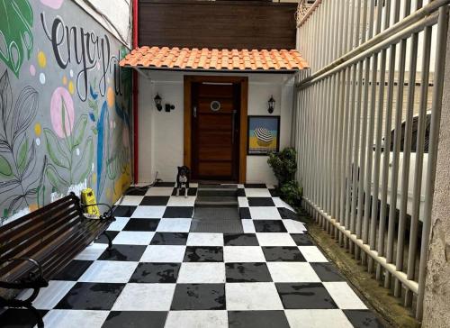 a hallway with a checkered floor and a door at Ipanema Club Hostel in Rio de Janeiro