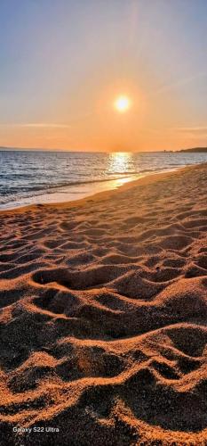a sunset on a beach with the ocean at Irini&Stefanos Toroni, Greece in Toroni