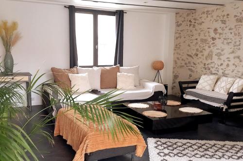 una sala de estar con un sofá y una mesa en Gite le Parveau, 3 étoiles meublé de tourisme, en La Guiltière