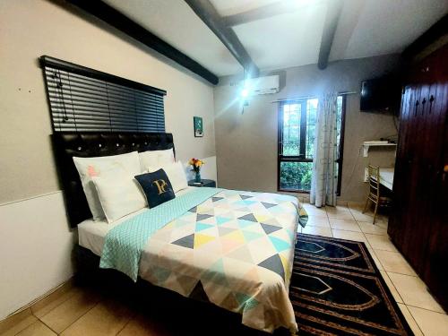 a bedroom with a bed in a room at Daven Guest House in Pietermaritzburg