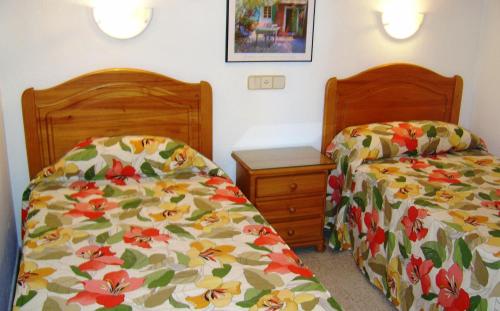 two beds sitting next to each other in a bedroom at Apartamentos Tamaragua in Playa del Ingles