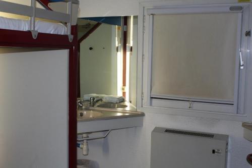 a bathroom with a sink and a mirror at hotelF1 Saint-Die in Saint Die