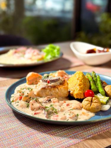 a plate of food with meat and vegetables on a table at Wyndham Garden Quito in Quito