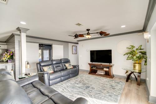 a living room with a couch and a flat screen tv at Front Row Beachfront Long Beach Getaway in Long Beach