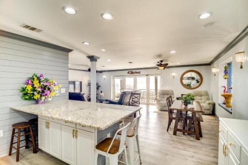 a kitchen and living room with a counter and chairs at Front Row Beachfront Long Beach Getaway in Long Beach