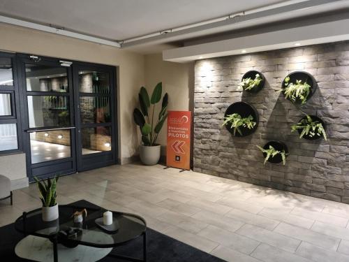 a lobby with plants on a brick wall at Departamento moderno y central en Chillan in Chillán