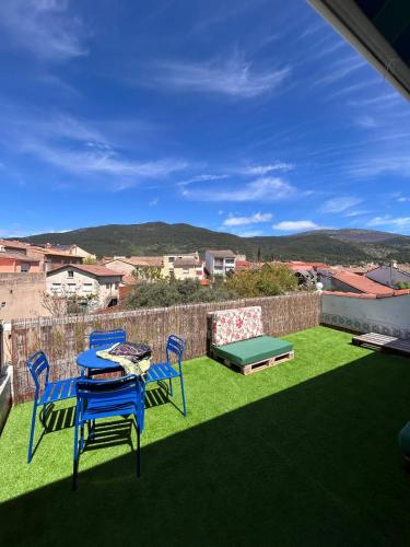 a patio with a table and chairs on the grass at House Casa in Sotillo de la Adrada in Sotillo de la Adrada