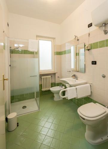 a bathroom with a toilet and a sink and a shower at Hotel La Rotonda in Cepagatti