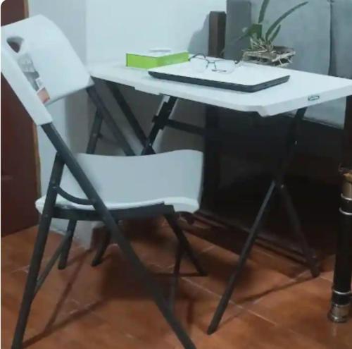 a white desk with a chair and a keyboard at Cuarto estudio HERSOR in San Salvador