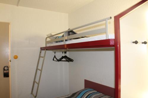 a bunk bed with a ladder in a room at hotelF1 Saint-Die in Saint Die