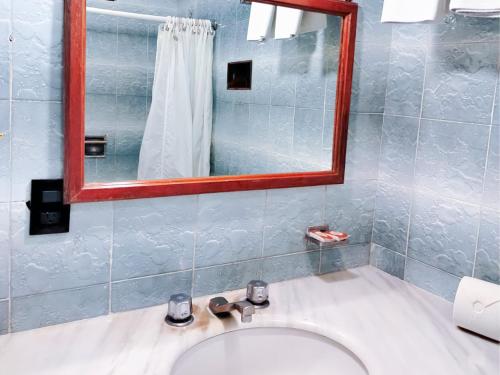 a bathroom with a white sink and a mirror at Hotel Frances in Guadalajara