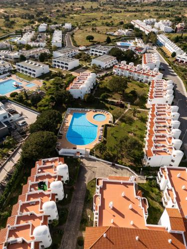 an aerial view of a resort with a swimming pool at Renovated Algarve Apartments with Pool in Armação de Pêra