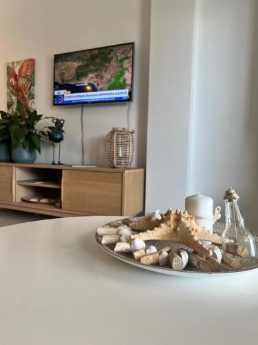 a plate with rocks on a table in a living room at Nea Peramos Apartment SeaFront in Néa Péramos