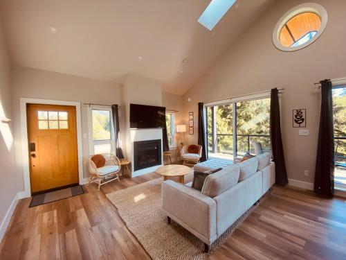 a living room with a couch and a table at Haven On The Hill in Port Renfrew