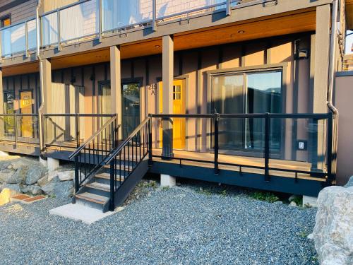 a building with a balcony and stairs on it at Haven On The Hill in Port Renfrew