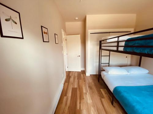 a bedroom with two bunk beds and a hallway at Haven On The Hill in Port Renfrew