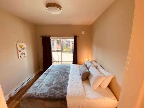 a bedroom with a large bed with white pillows at Haven On The Hill in Port Renfrew