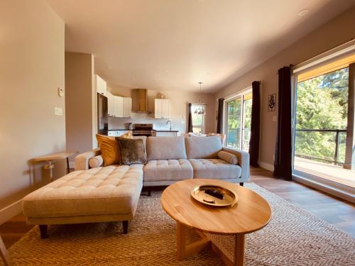 a living room with a couch and a table at Haven On The Hill in Port Renfrew