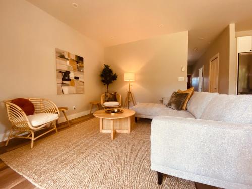 a living room with a couch and a table at Haven On The Hill in Port Renfrew