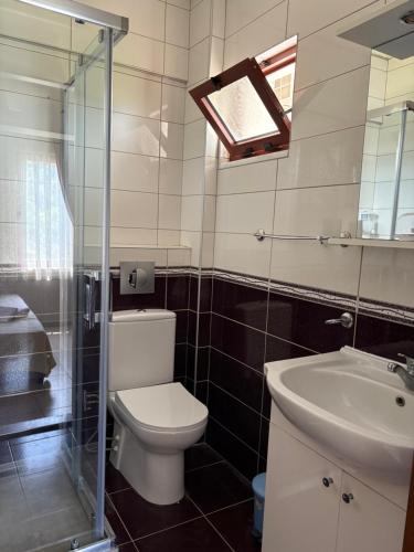 a bathroom with a toilet and a sink at Ebru'ca Pansiyon in Selimiye