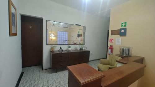 a bathroom with a sink and a mirror in a room at Uotan in Mexico City