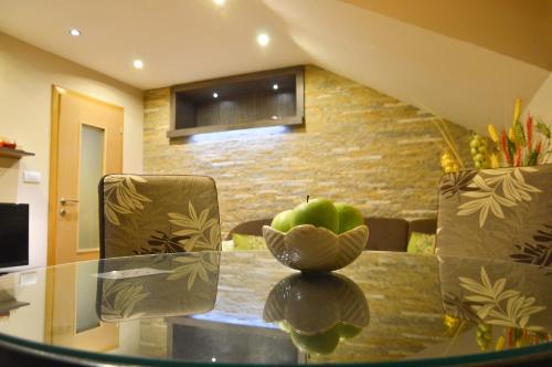 a table with a bowl of apples on top of it at Apartments Josipovic in Zlatibor