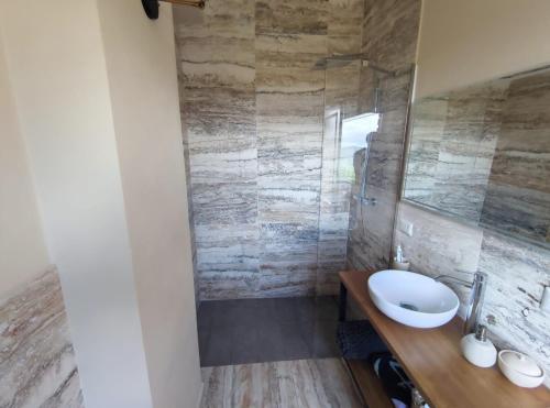 a bathroom with a sink and a shower at Happy Tuscany in Rigomagno
