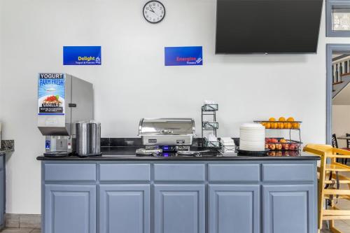 a kitchen with a blue counter top with a printer at Best Western Central Inn in Savannah
