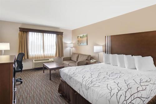 a hotel room with a bed and a couch at Best Western Brookfield in Brookfield