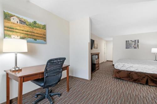 a hotel room with a desk and a bed at Best Western Brookfield in Brookfield