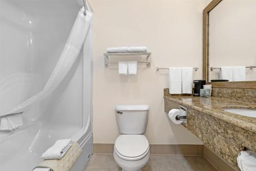 a bathroom with a toilet and a sink at Best Western Brookfield in Brookfield
