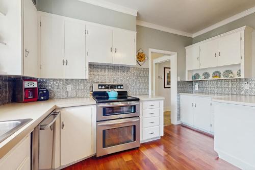 a kitchen with white cabinets and a stove top oven at The Harrison House in Boise
