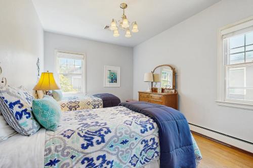 a bedroom with two beds and a mirror at The Harrison House in Boise