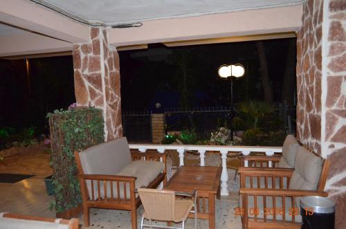 a patio with chairs and a table at Apartments Zoumperi in Nea Makri