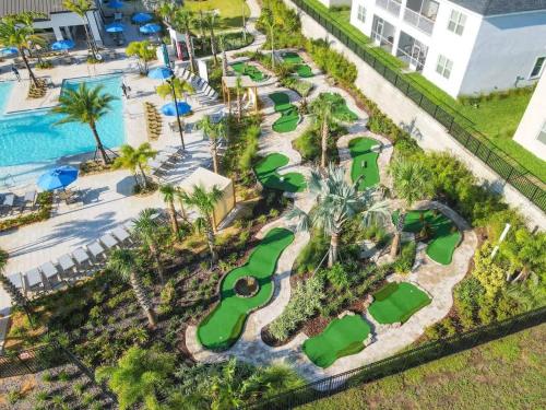 an aerial view of a golf course at a resort at Disney-Themed Townhome in ChampionsGate Resort 15 min from Disney World with 7 Pools, Gym, Golf, Lazy River, Water Park, Arcades, Theatre, and More! in Kissimmee