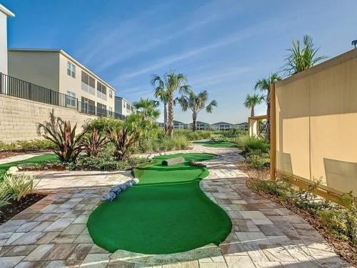 a golf course with a putting green in a resort at Wonderful Disney-Themed Home in ChampionsGate Resort 15 min from Disney World with 7 pools, Club houses, Water Park, Gym, Arcades, Lazy River, Golf, and More! in Kissimmee