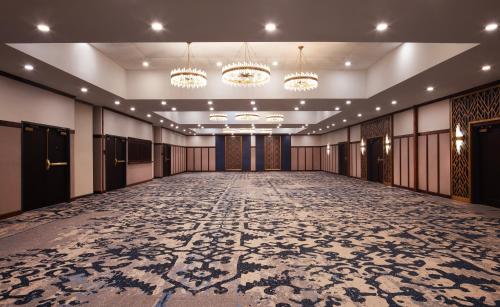 an empty ballroom with a large room with chandeliers at Hotel Royer Urbana Champaign, Tapestry Collection by Hilton in Champaign