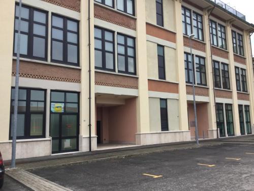 a building with a lot of windows on a street at Bella Italia Palace Hotel in Novara