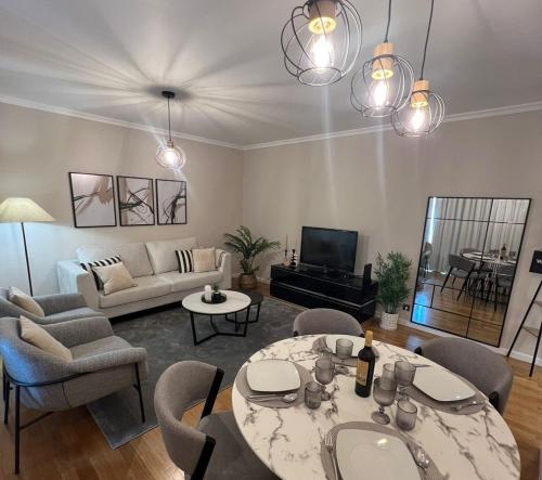 a living room with a couch and a table and chairs at Modern Urban Apartment in Funchal