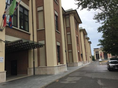 a building with a car parked in front of it at Bella Italia Palace Hotel in Novara