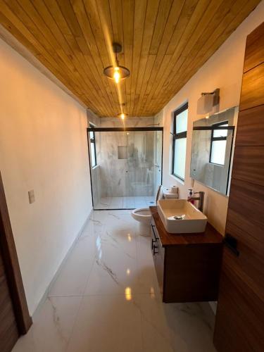 a bathroom with a sink and a toilet in it at Hermosa cabaña en el bosque in Mazamitla