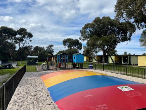 a playground at a park with a playground at Victor Harbor Holiday Park in Victor Harbor