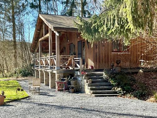 a small wooden house with stairs leading up to it at La Linotte in Arville