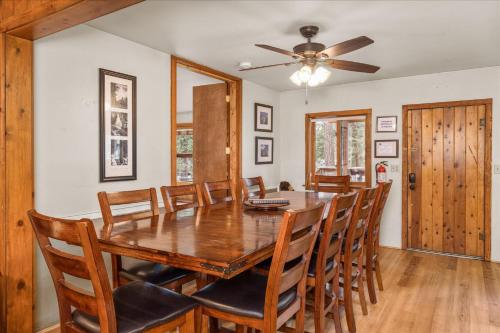a dining room with a wooden table and chairs at Cub House- Remodeled cabin INSIDE Yosemite with new hot tub and more in North Wawona